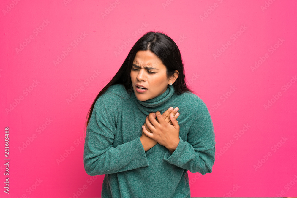 Young Colombian girl with green sweater having a pain in the heart Young Colombian girl with green sweater having a pain in the heart