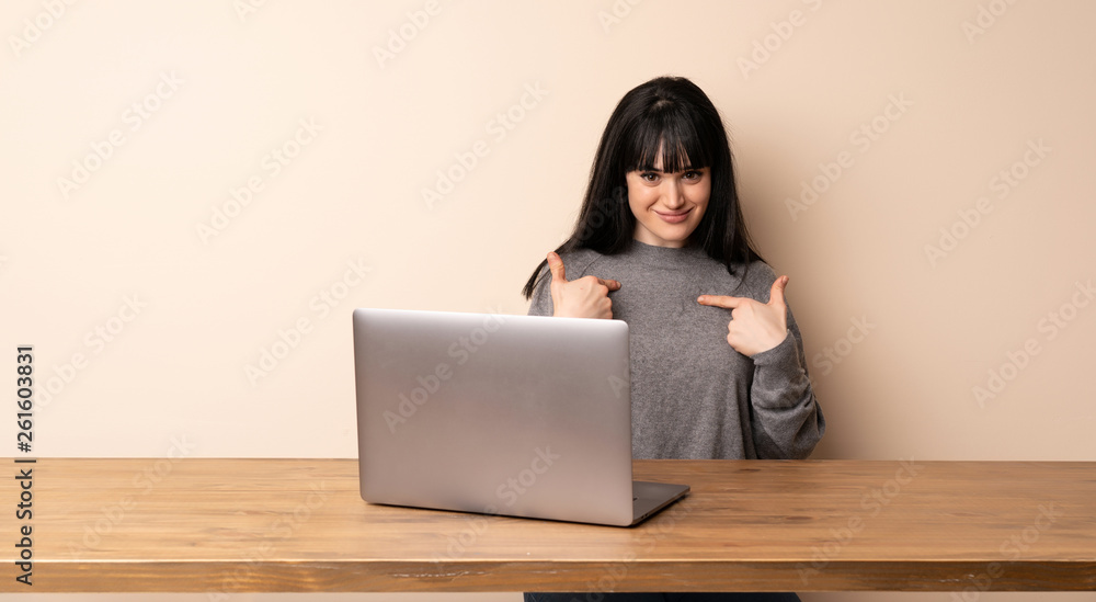 Young woman working with her laptop with surprise facial expression Young woman working with her laptop with surprise facial expression
