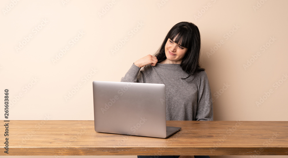 Young woman working with her laptop with tired and sick expression Young woman working with her laptop with tired and sick expression