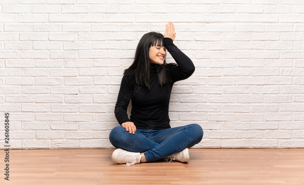 Woman sitting on the floor has realized something and intending the solution Woman sitting on the floor has realized something and intending the solution