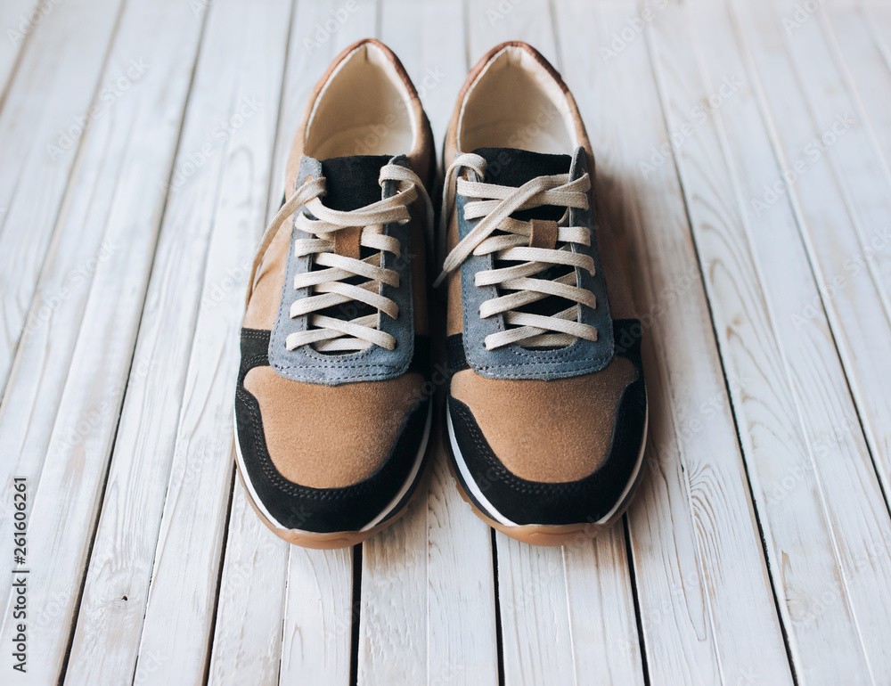 Intensiv Awaken maler A pair of new suede sneakers on a rustic wooden background. The concept of  jog and sports shoes. Stock Photo | Adobe Stock