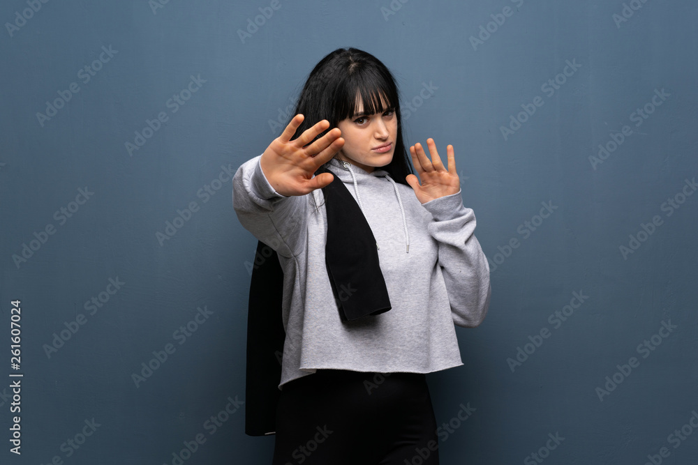 Young sport woman nervous and scared stretching hands to the front Young sport woman nervous and scared stretching hands to the front