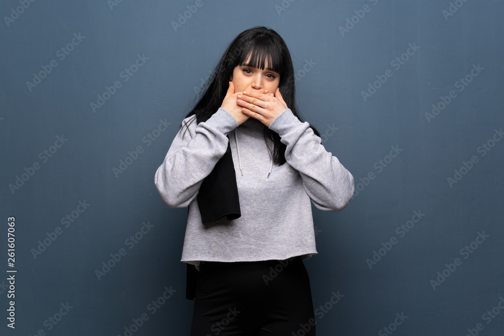 Young sport woman covering mouth with hands for saying something inappropriate Young sport woman covering mouth with hands for saying something inappropriate