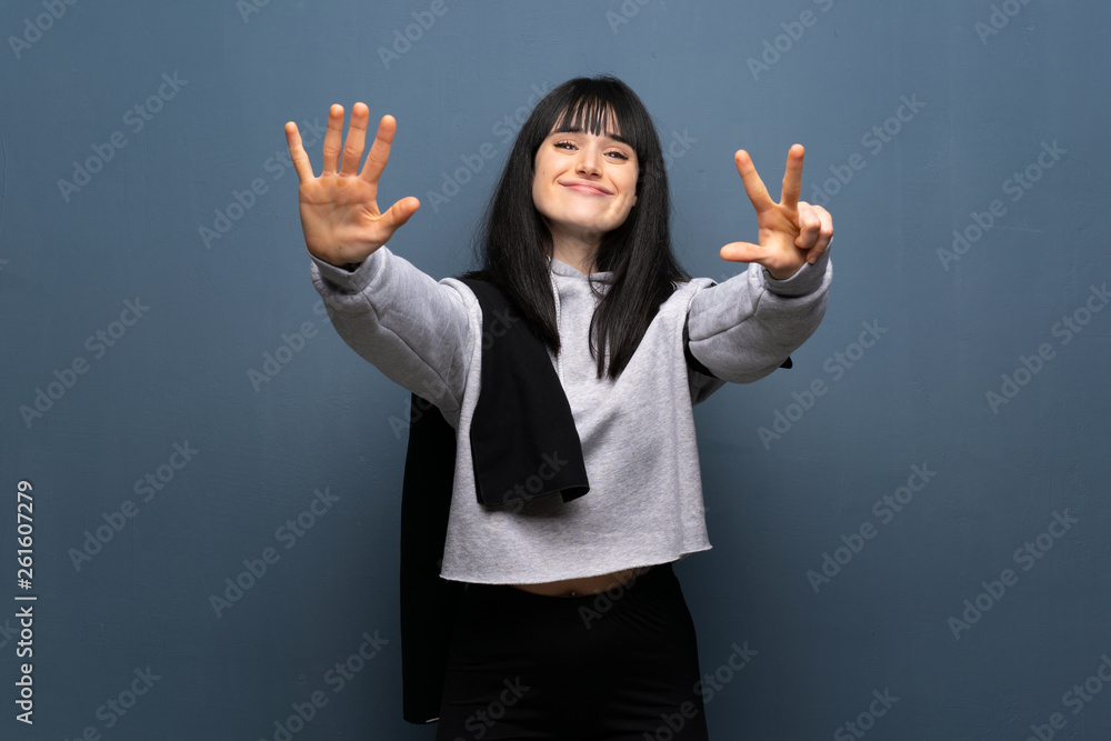 Young sport woman counting eight with fingers Young sport woman counting eight with fingers