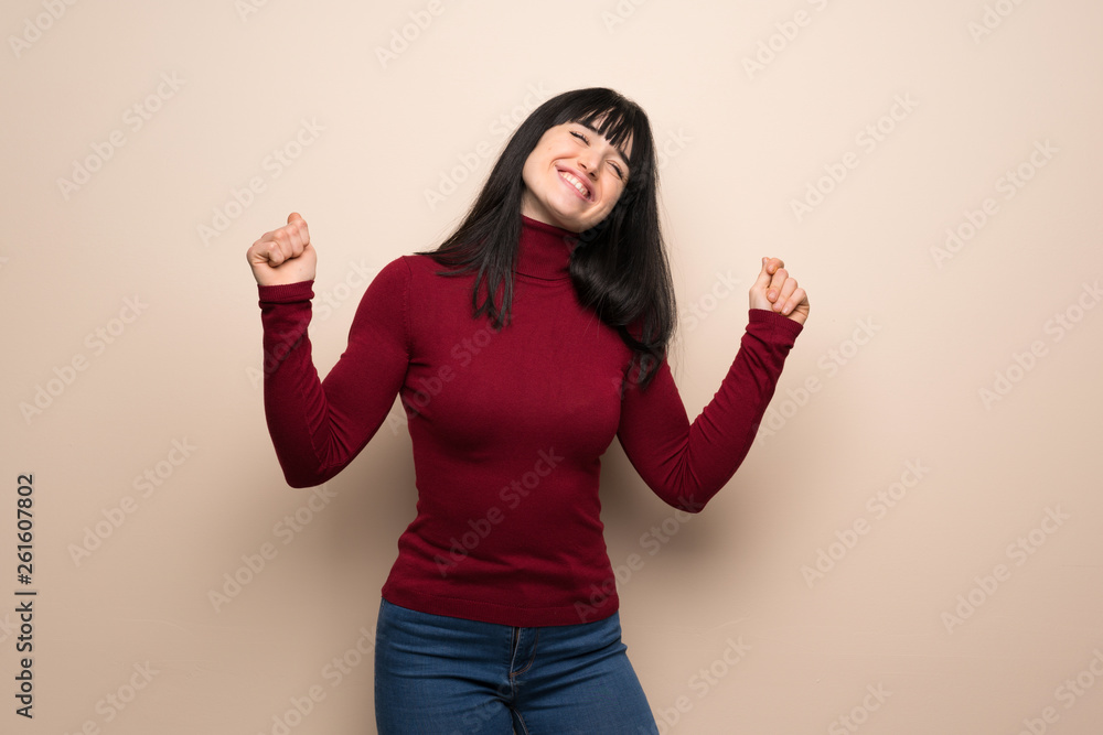 Young woman with red turtleneck enjoy dancing while listening to music at a party Young woman with red turtleneck enjoy dancing while listening to music at a party