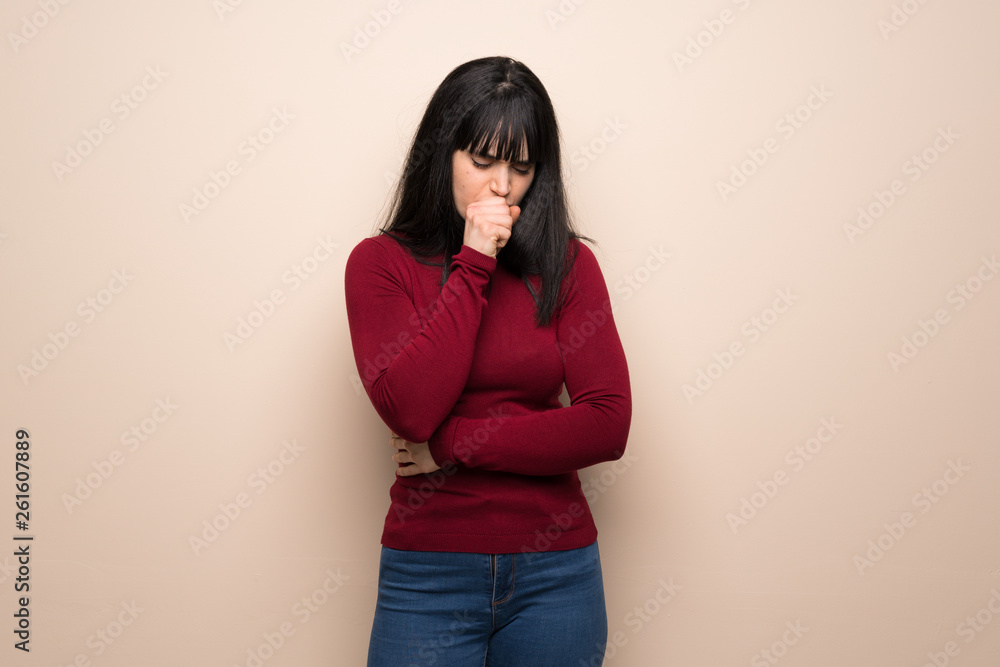 Young woman with red turtleneck is suffering with cough and feeling bad Young woman with red turtleneck is suffering with cough and feeling bad