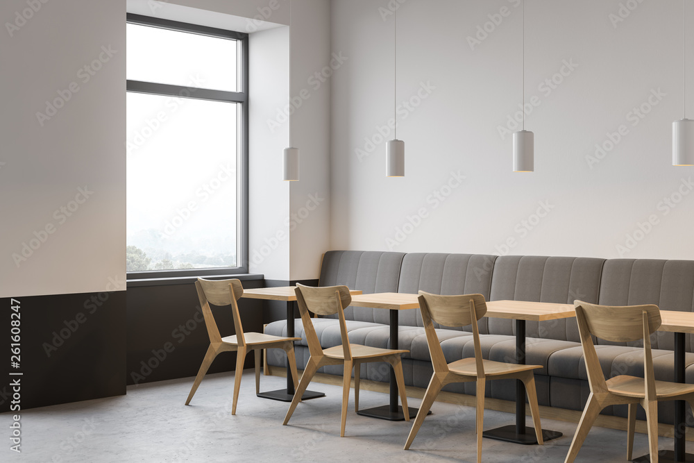 Corner of white restaurant with sofa and chairs Corner of white restaurant with sofa and chairs