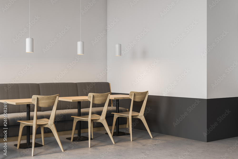 Fototapeta premium Corner of white cafe with sofa and chairs