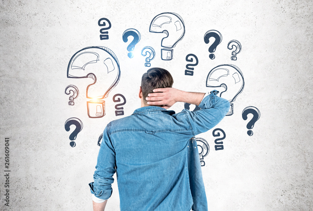 Man scratching head looking at question marks Man scratching head looking at question marks