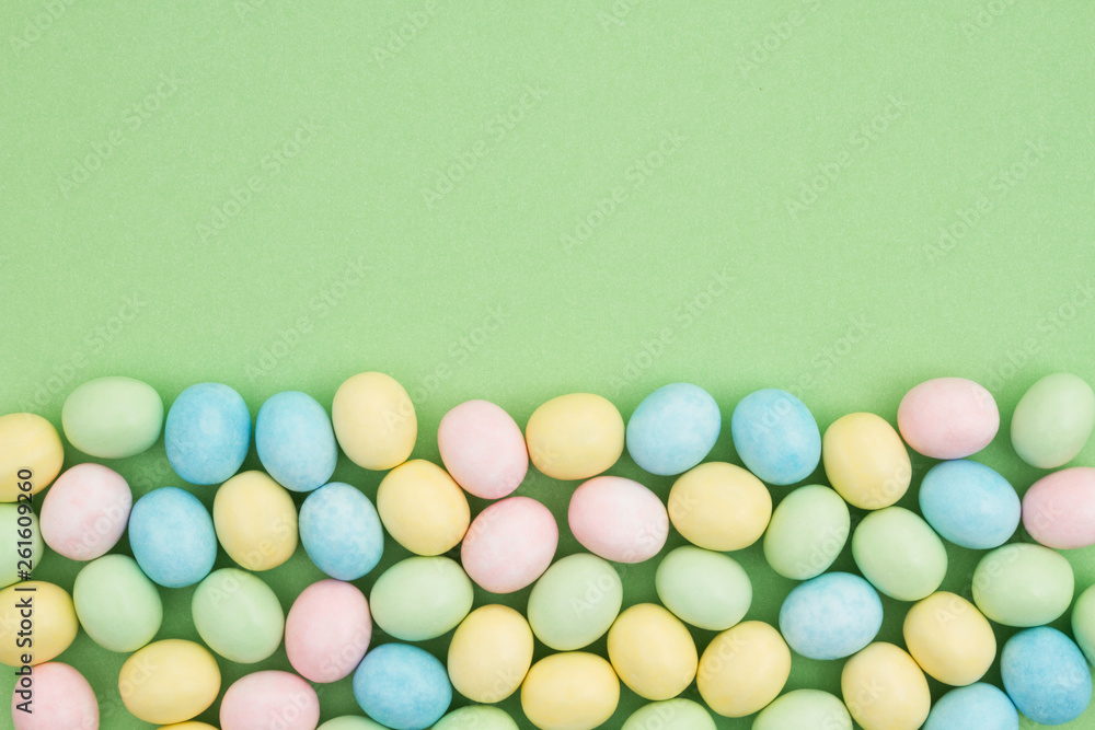 Obraz premium Candy Easter egg background green paper