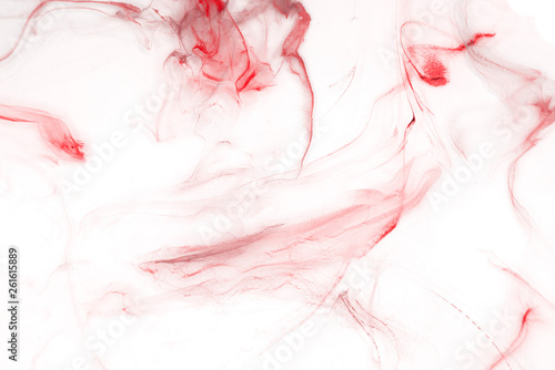 Red alcohol ink texture with abstract washes and paint stains on the white paper background. 