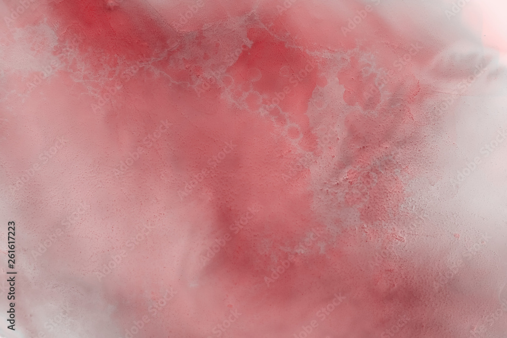 Fototapeta premium Red alcohol ink texture with abstract washes and paint stains on the white paper background.