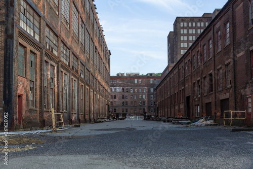 Street through a complex of derelict industrial buildings  daylight  horizontal aspect