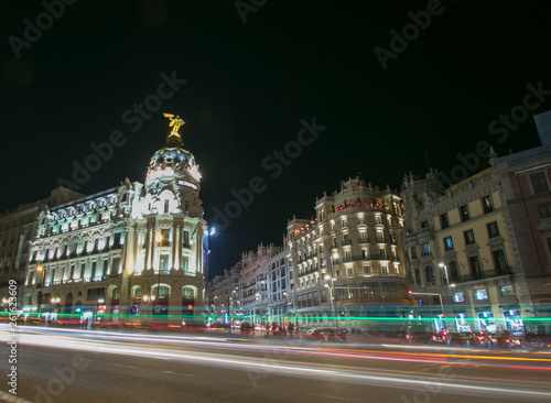 Rays of traffic lights on Gran via street, main shopping street in Madrid at night. Spain, Europe