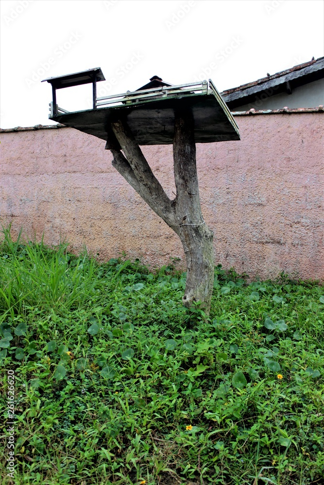 Handmade bird house, made with planks and trunk of old wood composing the garden decoration, in Ubatuba, São Paulo - Brazil. Handmade bird house, made with planks and trunk of old wood composing the garden decoration, in Ubatuba, São Paulo - Brazil.