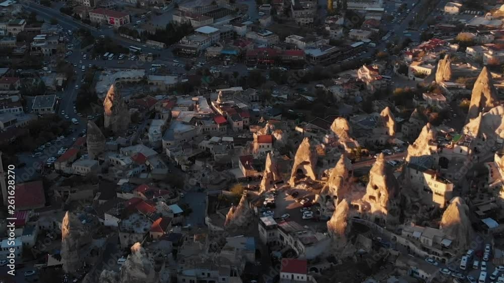 Aerial view to Goreme city and the valley, illuminated by sun, Cappadocia, Turkey Aerial view to Goreme city and the valley, illuminated by sun, Cappadocia, Turkey