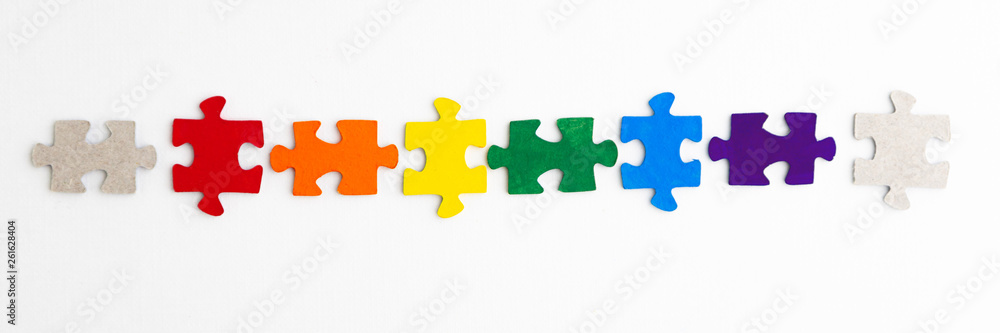 equality concept: LGBT pride flag built from a puzzle, among gray puzzles short focus, top view equality concept: LGBT pride flag built from a puzzle, among gray puzzles short focus, top view