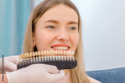 Young woman with health teeth and hold teeth whitening tool