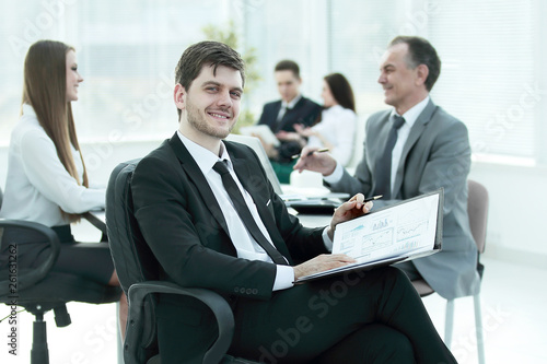 business man at office with his business team working behind