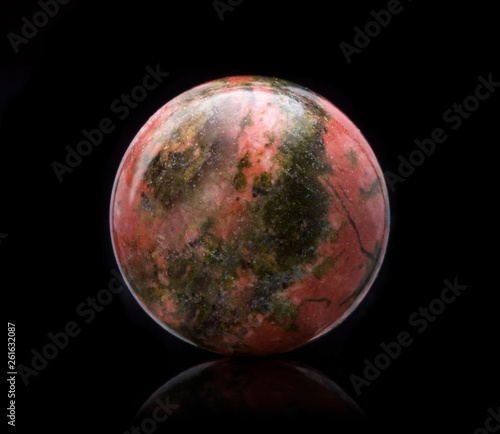 Mineral Unakite with reflection on black surface background