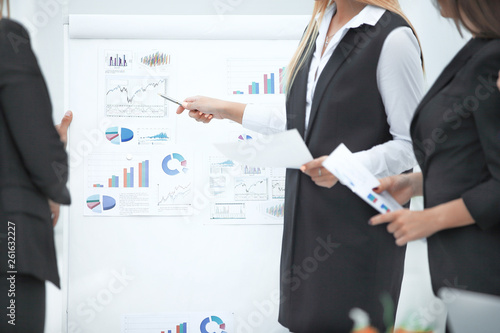 close up. business woman showing a pen on a flipchart ,with financial data