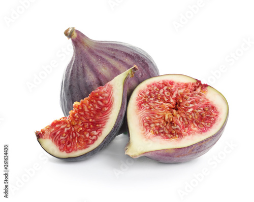 Whole and cut purple figs on white background