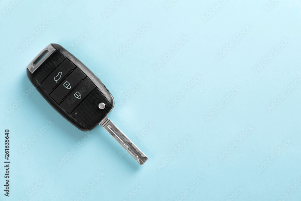 Car key on color background, top view with space for text