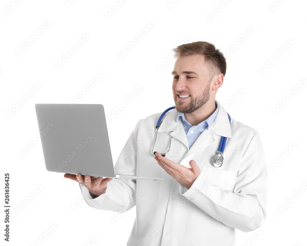 Male doctor using video chat on laptop against white background Male doctor using video chat on laptop against white background