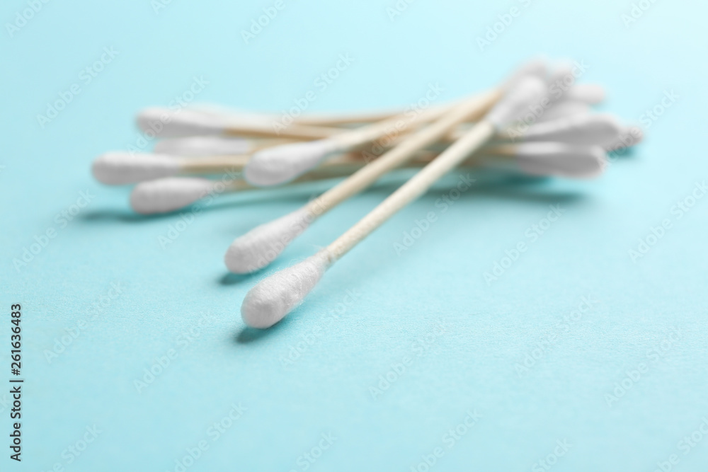 Pile of cotton swabs and space for text on color background Pile of cotton swabs and space for text on color background