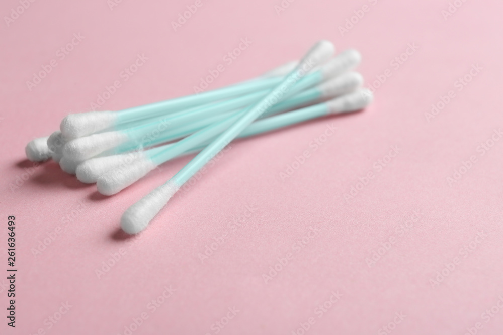 Pile of cotton swabs and space for text on color background Pile of cotton swabs and space for text on color background