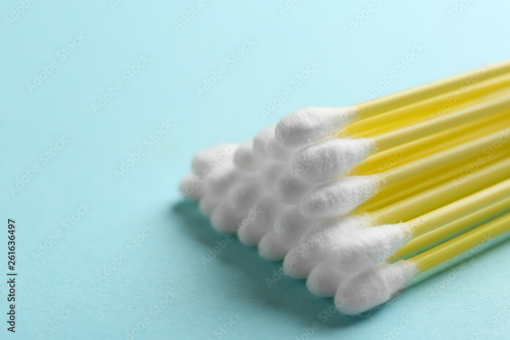 Pile of cotton swabs on color background, closeup. Space for text Pile of cotton swabs on color background, closeup. Space for text