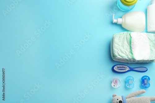 Flat lay composition with baby accessories and space for text on color background photo