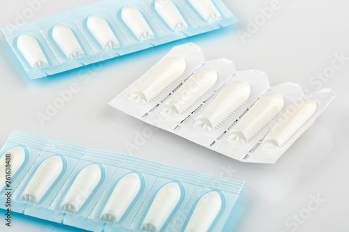 Blue and white packages with suppository on white background