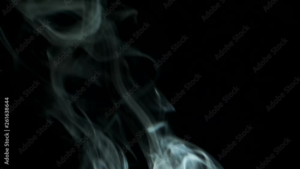 Trickle smoke rising graceful twists upward. Cigar smoke blowing from bottom to top. Natural color tobacco smoke. Great for editing, video without color correction and grading, 4K - 60fps Trickle smoke rising graceful twists upward. Cigar smoke blowing from bottom to top. Natural color tobacco smoke. Great for editing, video without color correction and grading, 4K - 60fps