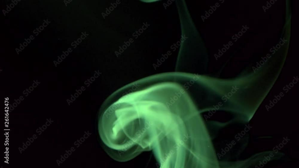 Bright green smoke slowly billow rising swirl up. Colored smoke blowing to top. Closeup, isolated on black background. Bright green smoke slowly billow rising swirl up. Colored smoke blowing to top. Closeup, isolated on black background.