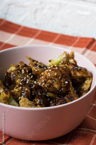 general tso cauliflower with chicken breast consist of fried cauliflower in sourly soy sauce  photo