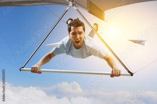 Wallpaper Mural Young man flying on hang glider. Mixed media Torontodigital.ca