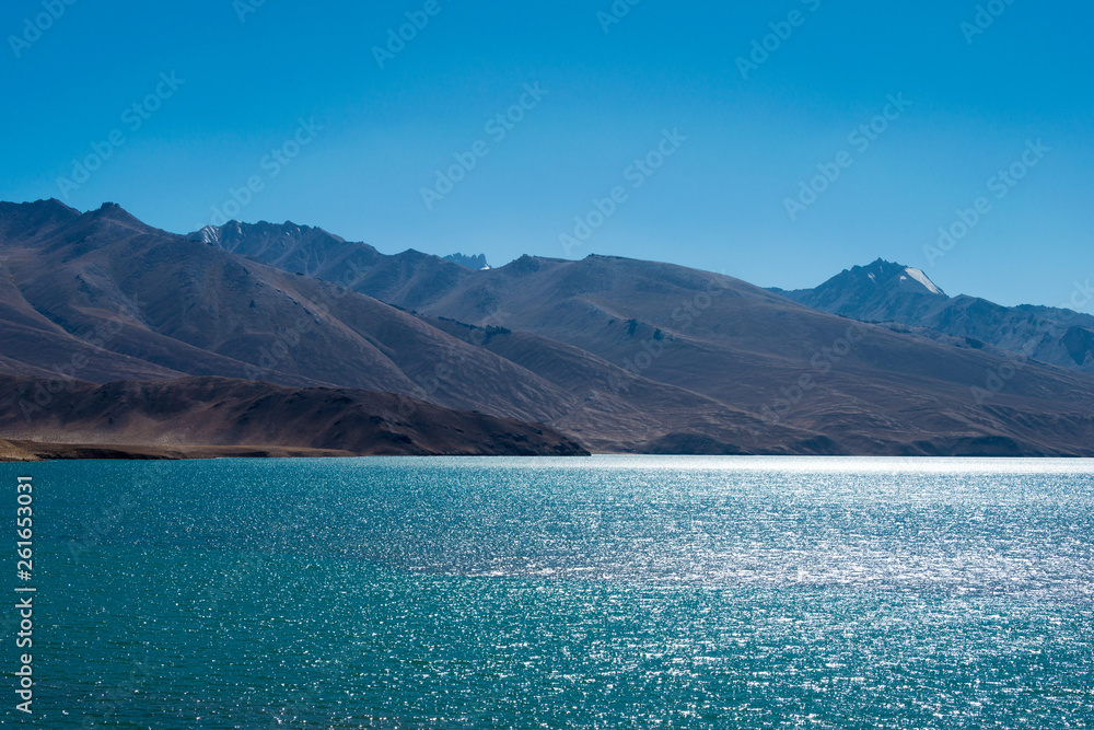 Fototapeta Pamir Mountains, Tajikistan - Aug 21 2018: Yashilkul Lake in Gorno-Badakhshan, Tajikistan. It is located in the World Heritage Site Tajik National Park (Mountains of the Pamirs).