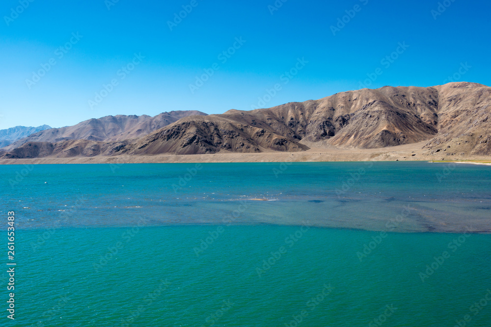 Obraz premium Pamir Mountains, Tajikistan - Aug 21 2018: Yashilkul Lake in Gorno-Badakhshan, Tajikistan. It is located in the World Heritage Site Tajik National Park (Mountains of the Pamirs).