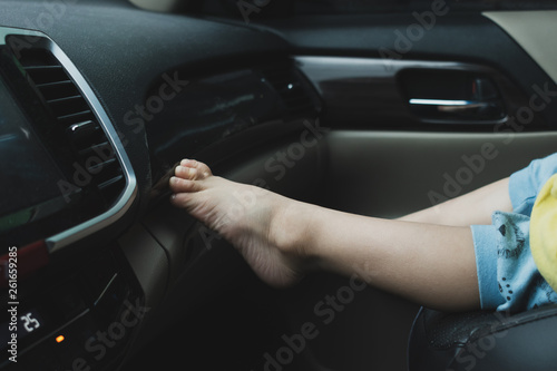 child sitting on front seat of car