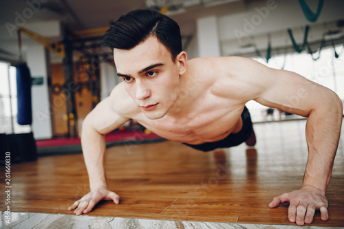 Handsome man in a gym. Sportsman in a sportswear. Guy training