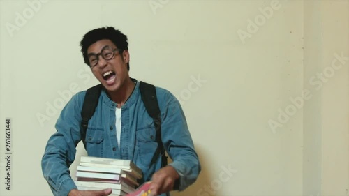 Man asian Overdo reading work without break For education to insupportable insufferable strain throwing the book on wall background