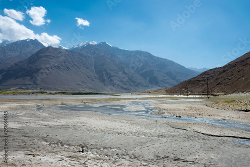 Pamir Mountains, Tajikistan - Aug 22 2018: Afghanistan and Panj river at Wakhan Valley View from Zugvand Village, Gorno-Badakhshan, Tajikistan. It is located in the Tajikistan and Afghanistan border.