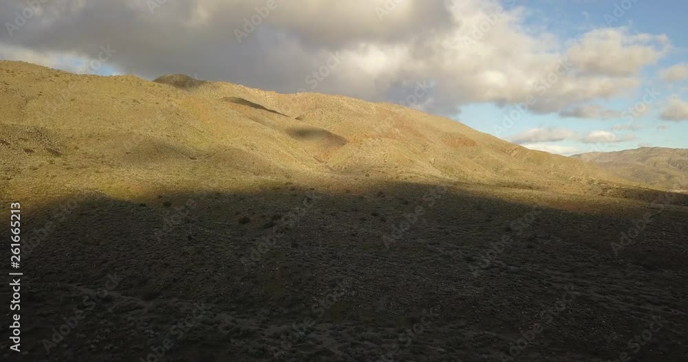 Sun begins to set over Anza Borrego State Park, shadows covering wide open desert landscape, Aerial Rise Shot Sun begins to set over Anza Borrego State Park, shadows covering wide open desert landscape, Aerial Rise Shot