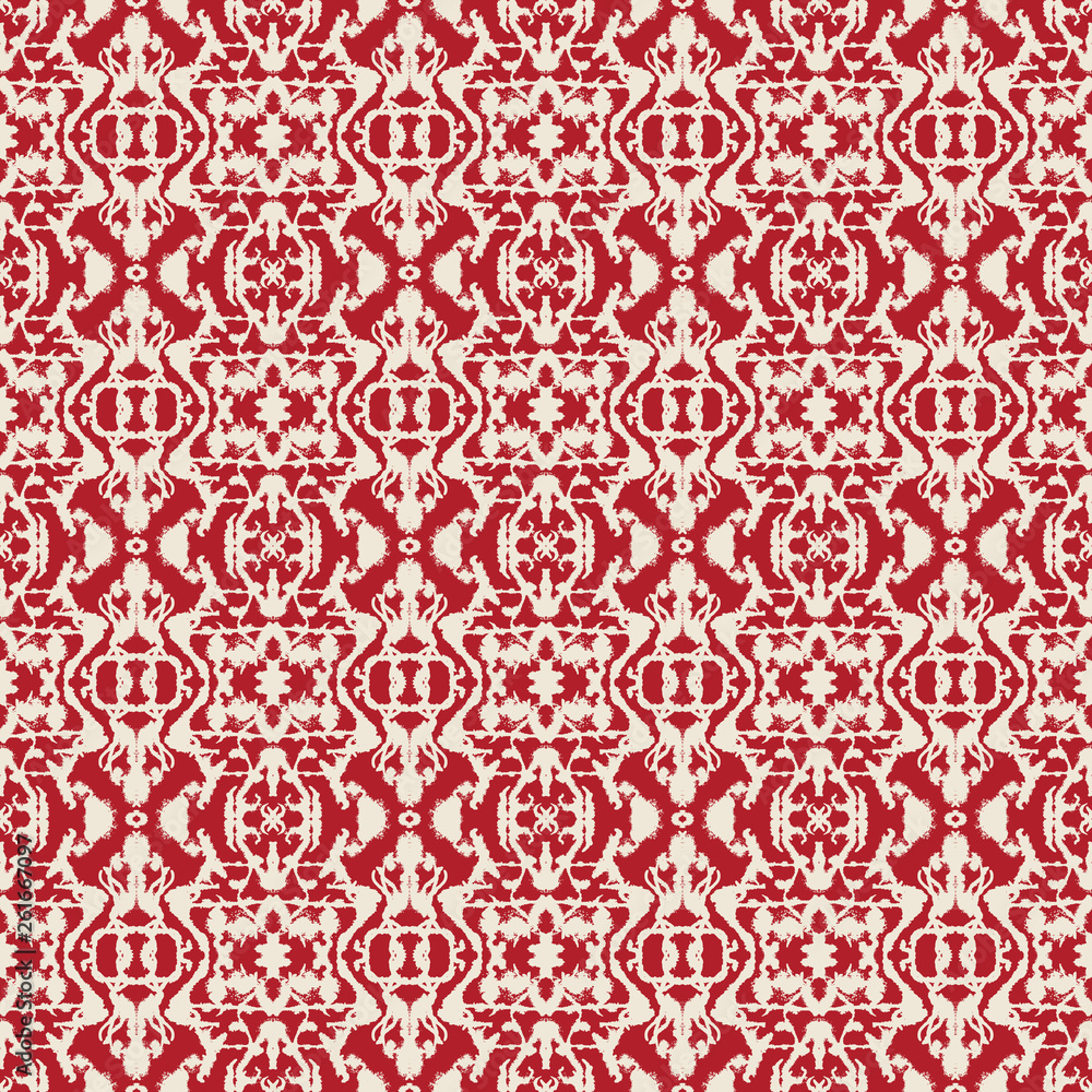 Abstract seamless pattern with mirrored symmetrical, marbled shapes in red and cream.