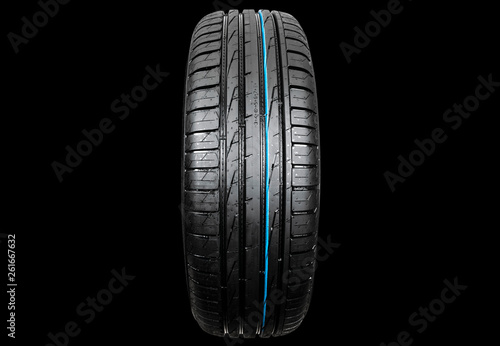 Studio shot of a set of summer car tire isolated on black background. Tire stack. Car tyre protector close up. Black rubber tire. Brand new car tires. Close up black tyre profile. Car tires in a row