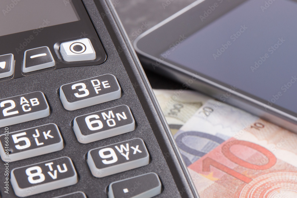 Credit card reader, mobile phone with NFC technology and curriencies euro. Cash or cashless payment transaction