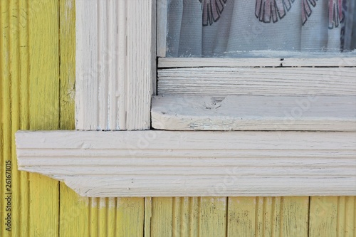 old retro wood white window in the yellow wood wall