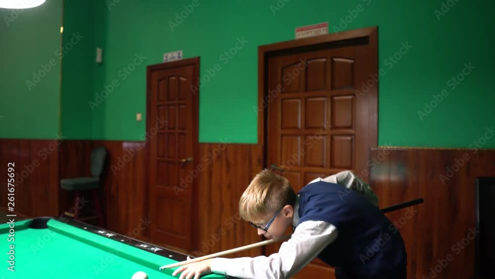 American pool, swimming pool for nine balls. The boy plays billiards, snooker. American pool, swimming pool for nine balls. The boy plays billiards, snooker.