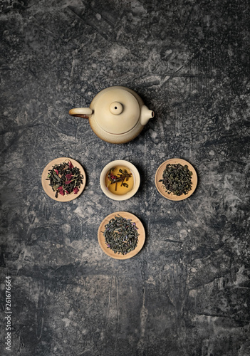 tea ceremony concept, Chinese or japanese traditions. teapot, cup of tea on dark background, several kinds of tea welding. variety of tea selection. Asia culture design concept. Top view, copy space